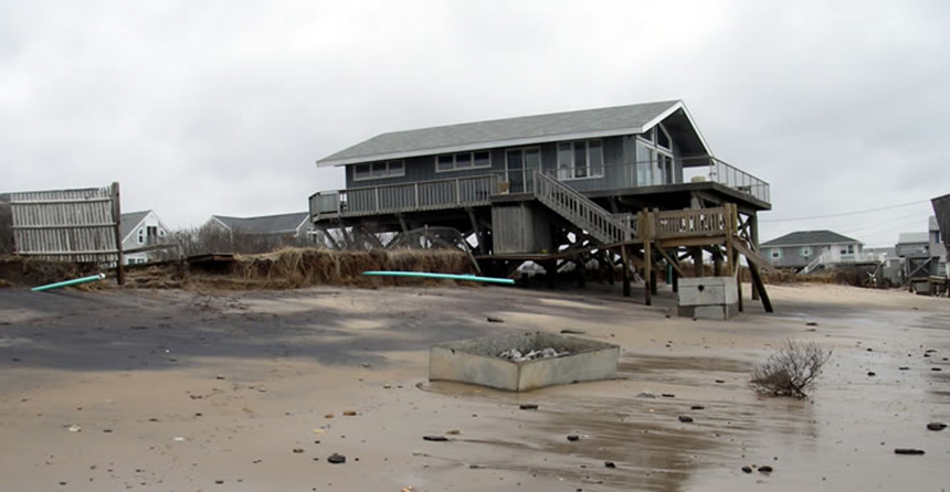 Beach house threatened by erosion