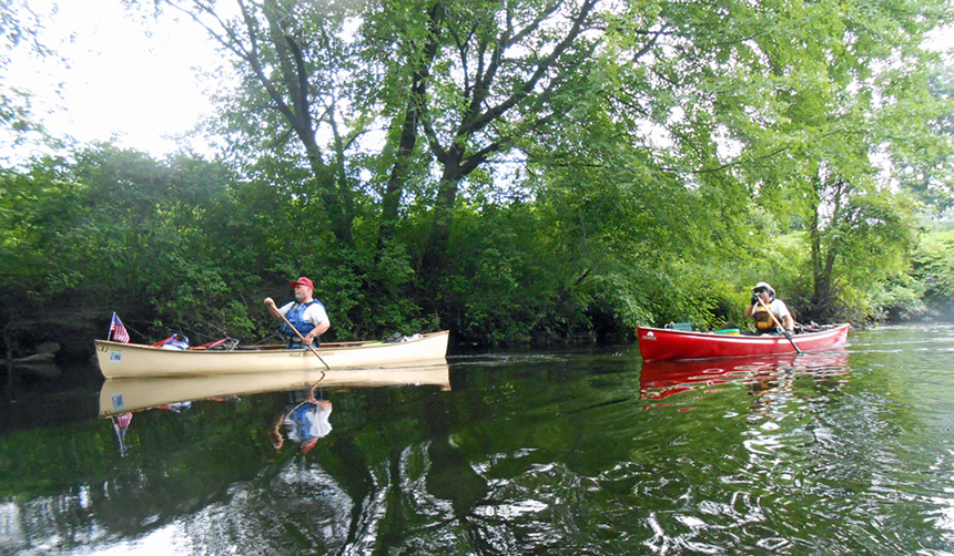 Men in canoes on the river