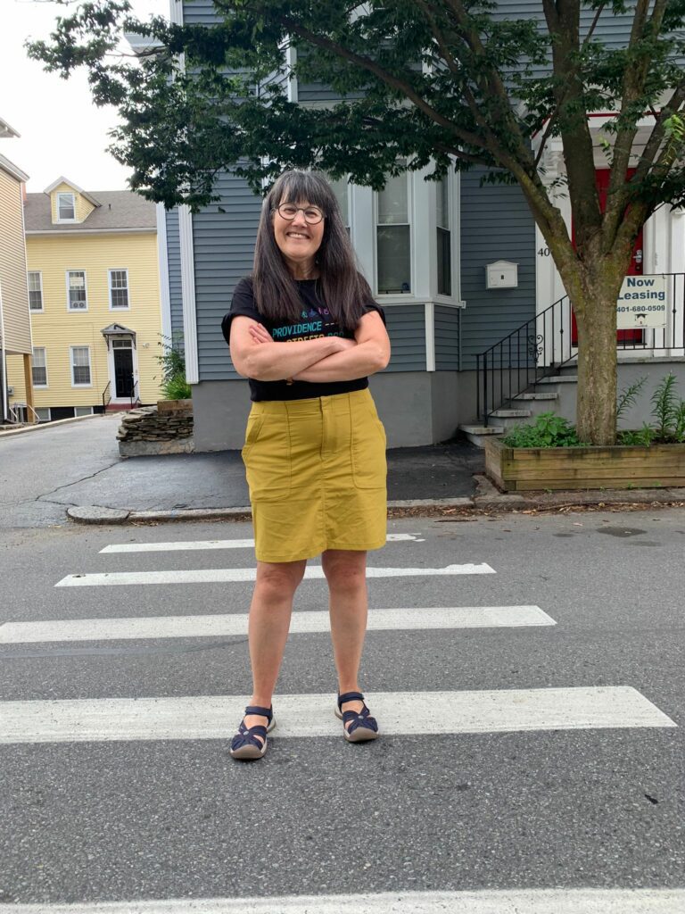 woman stands on crosswalk