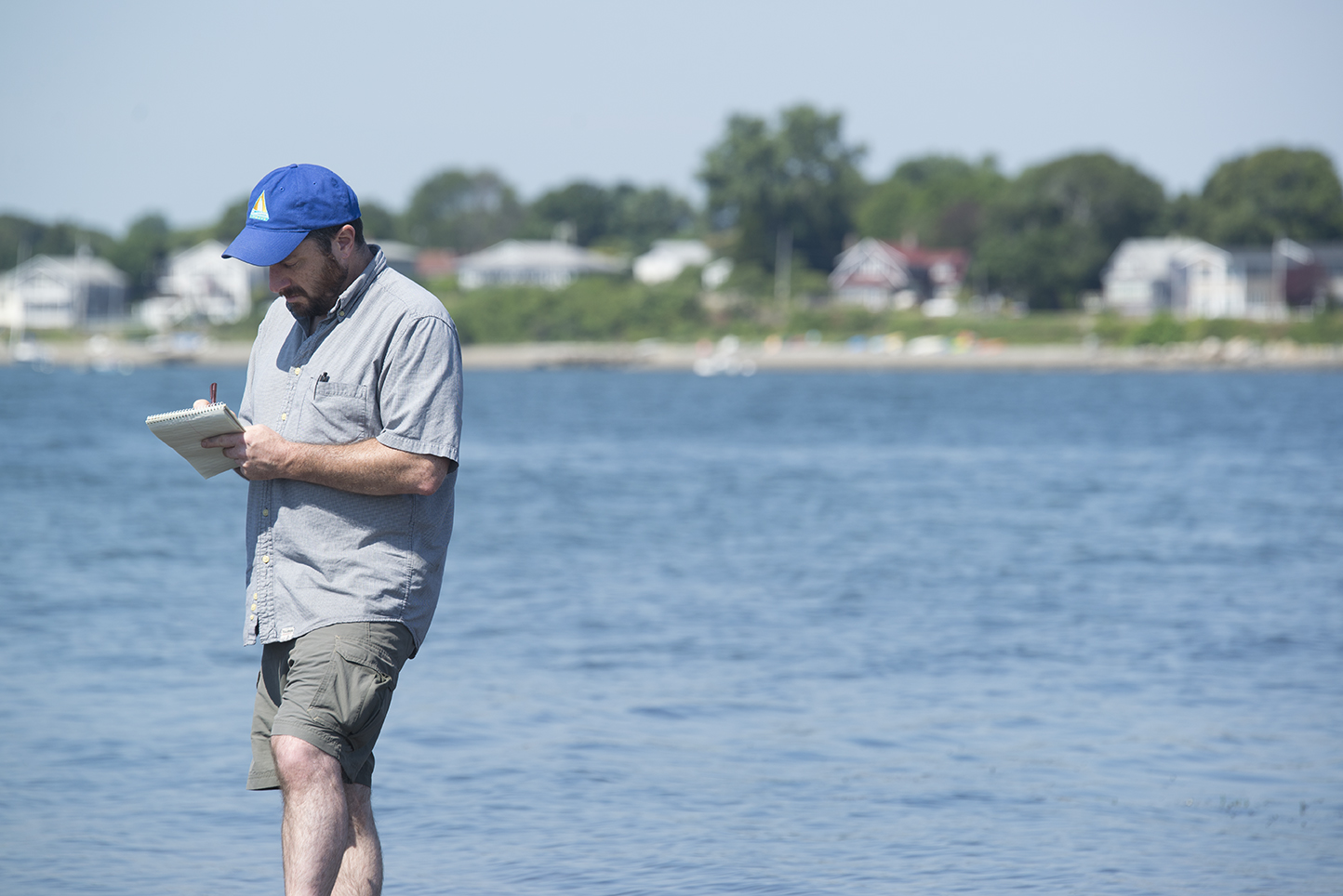 Frank Carini holding notebook reporting by Narragansett Bay