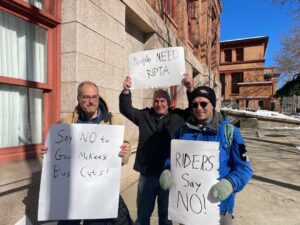 protesters hold signs